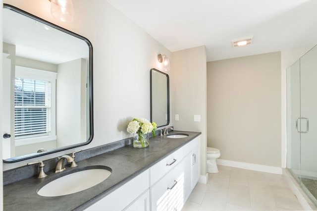 bathroom with toilet, vanity, tile patterned flooring, and a shower with shower door