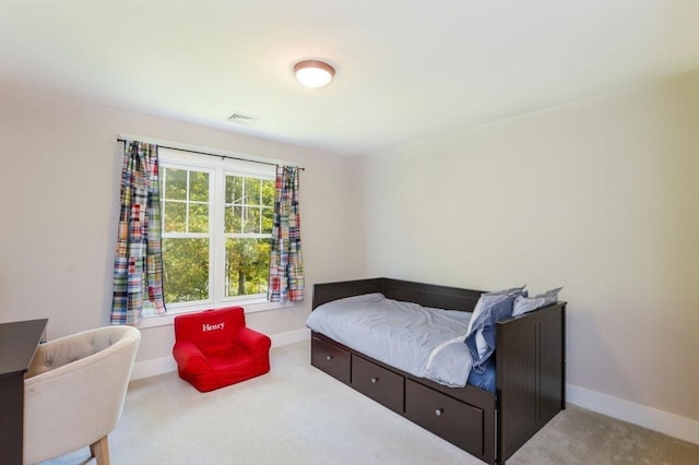 bedroom with light colored carpet