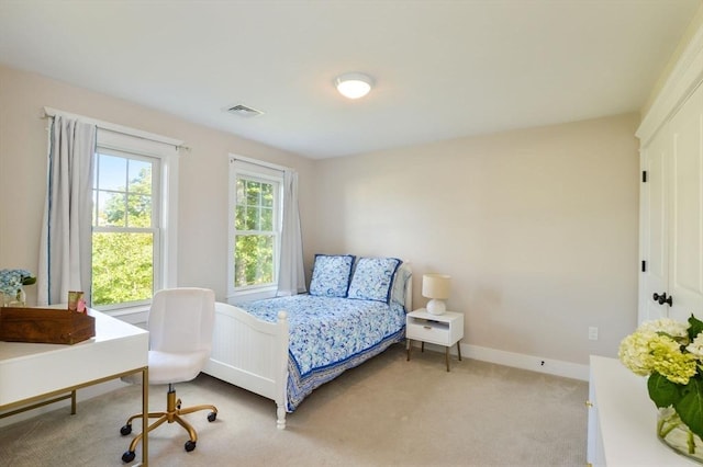 bedroom with light colored carpet