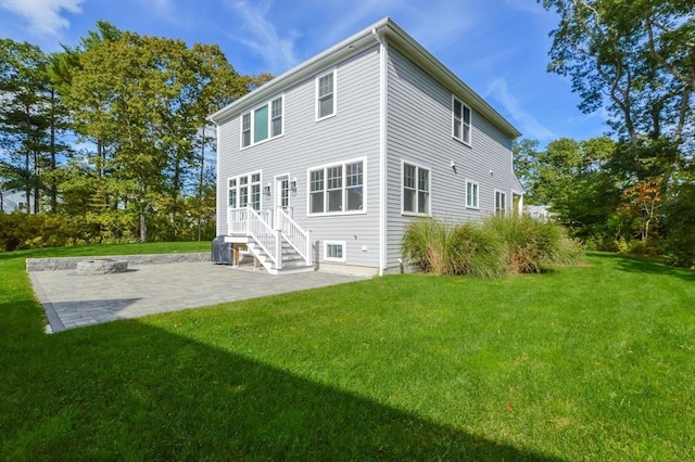 rear view of house with a yard and a patio