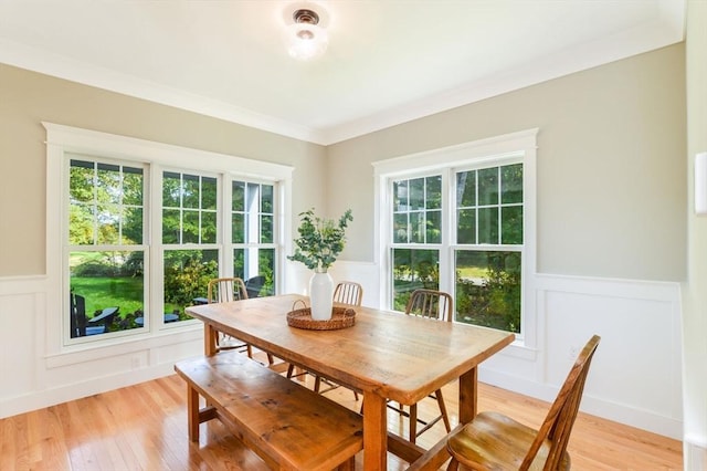 dining room with light hardwood / wood-style floors and ornamental molding