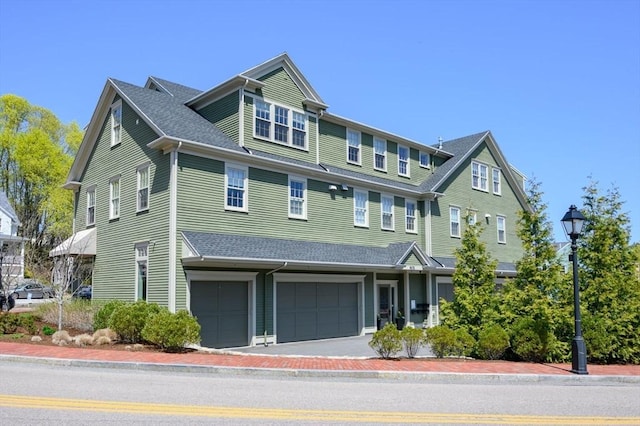 view of front of property featuring an attached garage and aphalt driveway