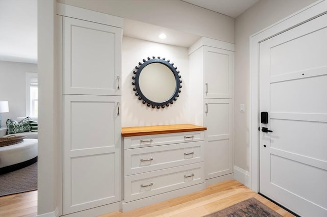 mudroom featuring baseboards, recessed lighting, and light wood-style flooring