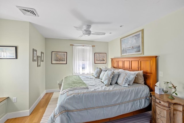 bedroom with ceiling fan and light hardwood / wood-style floors