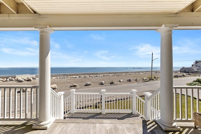 deck featuring a water view and a view of the beach