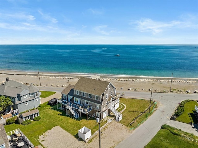 bird's eye view with a water view and a beach view