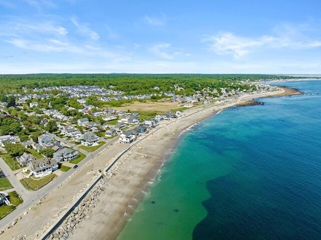 birds eye view of property with a beach view and a water view