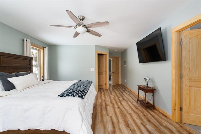 bedroom featuring light wood-style floors, ceiling fan, and baseboards