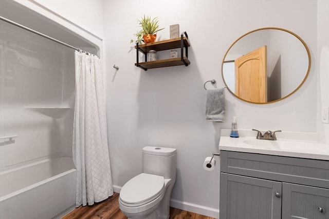 full bath featuring baseboards, toilet, wood finished floors, shower / bath combination with curtain, and vanity