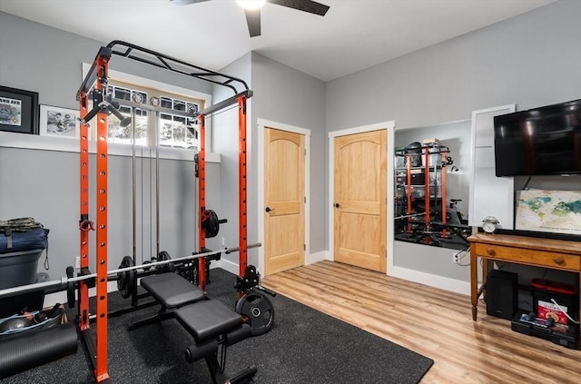 workout area with ceiling fan, wood finished floors, and baseboards