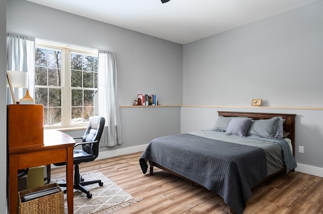 bedroom with baseboards and wood finished floors