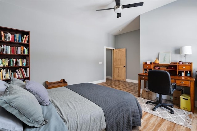 bedroom featuring light wood-type flooring, a ceiling fan, and baseboards