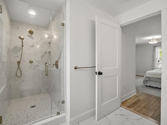 full bathroom with baseboards, ensuite bathroom, a marble finish shower, and marble finish floor