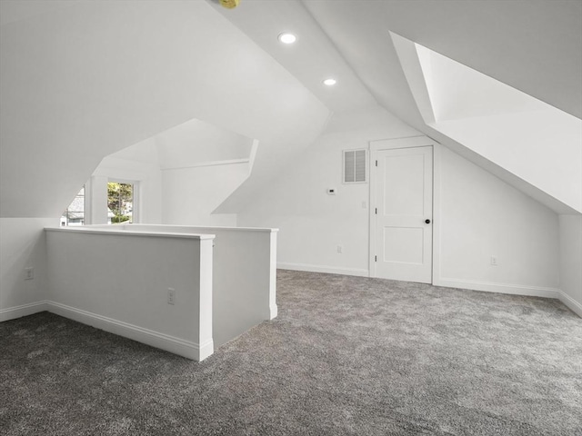 additional living space with visible vents, recessed lighting, carpet floors, and lofted ceiling