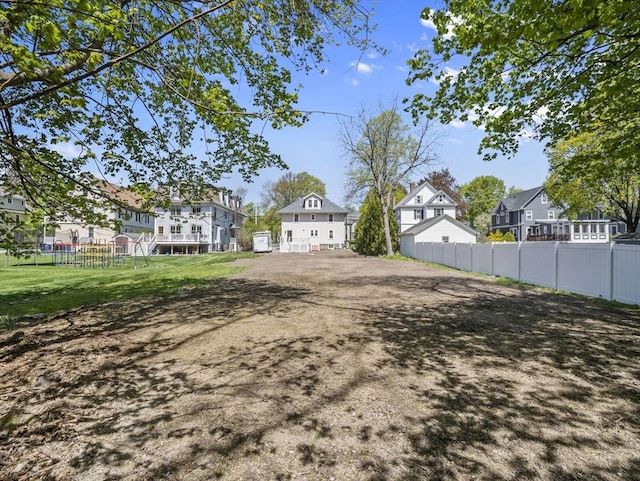 view of yard featuring fence and a residential view