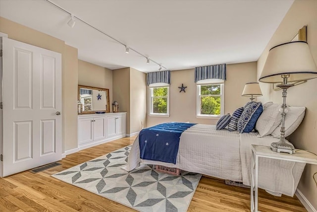 26 Sandy Meadow Way, Eastham, MA 02642 - bedroom with rail lighting and wood finished floors