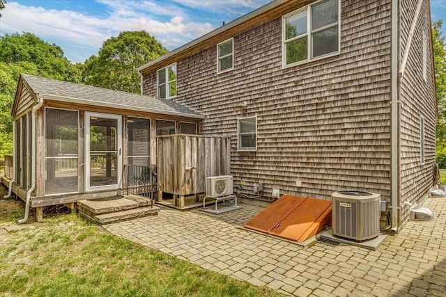 26 Sandy Meadow Way, Eastham, MA 02642 - back of property featuring a sunroom and a patio area