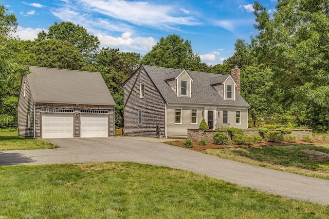 26 Sandy Meadow Way, Eastham, MA 02642 - cape cod house with a chimney, an outbuilding, a garage, driveway, and a front lawn