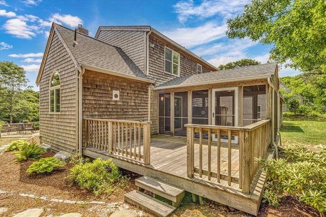 26 Sandy Meadow Way, Eastham, MA 02642 - back of property with a sunroom, a chimney, roof with shingles, and a deck
