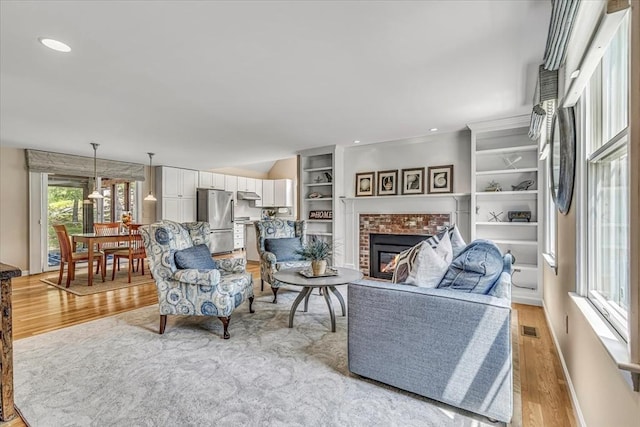 26 Sandy Meadow Way, Eastham, MA 02642 - living room with light wood-style flooring and a fireplace