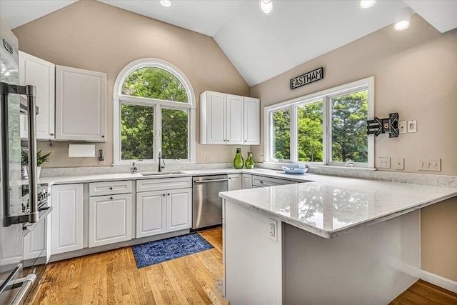 26 Sandy Meadow Way, Eastham, MA 02642 - kitchen with dishwasher, a peninsula, vaulted ceiling, white cabinetry, and light wood-style flooring