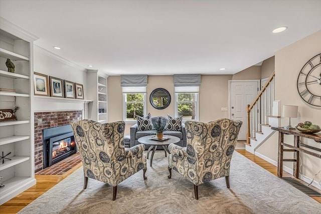 26 Sandy Meadow Way, Eastham, MA 02642 - living area featuring wood finished floors, a brick fireplace, stairs, recessed lighting, and built in features