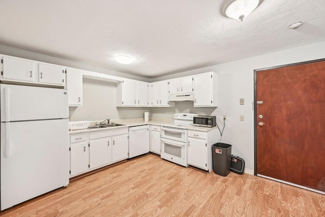 kitchen with sink, white cabinets, white appliances, and light hardwood / wood-style flooring