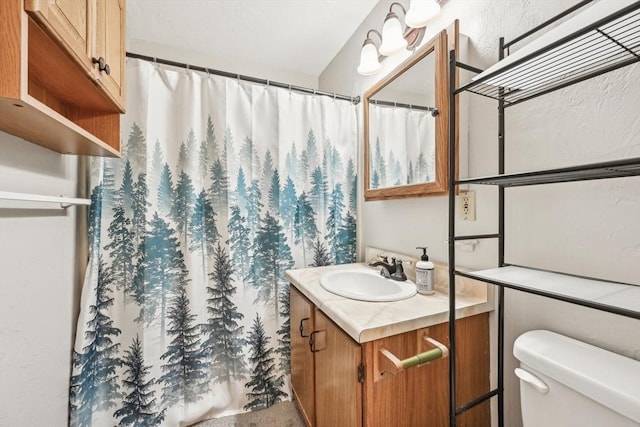 bathroom featuring vanity and toilet