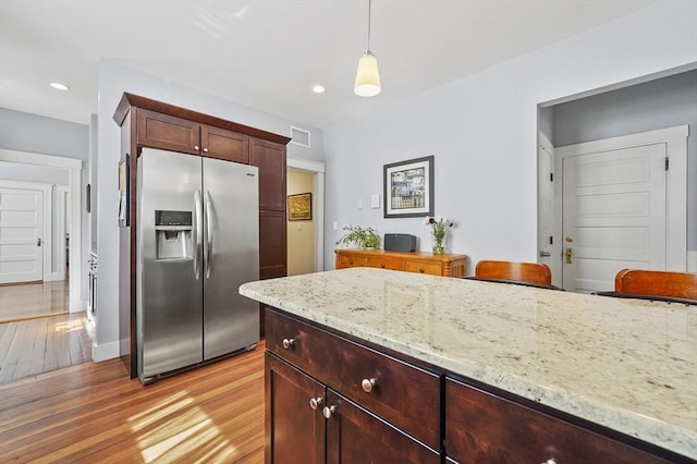 46 Converse Ave Unit 1, Malden, MA 02148 - kitchen with stainless steel fridge with ice dispenser, light wood finished floors, decorative light fixtures, light stone countertops, and recessed lighting