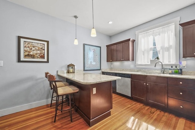 46 Converse Ave Unit 1, Malden, MA 02148 - kitchen with stainless steel dishwasher, wood finished floors, a peninsula, a breakfast bar area, and recessed lighting