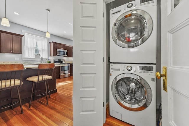 46 Converse Ave Unit 1, Malden, MA 02148 - laundry room featuring stacked washer / dryer, wood finished floors, and recessed lighting