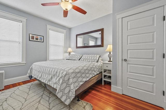 46 Converse Ave Unit 1, Malden, MA 02148 - bedroom featuring baseboards, wood finished floors, multiple windows, and a ceiling fan