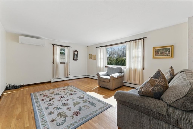 living area featuring a wall unit AC, wood finished floors, and a healthy amount of sunlight