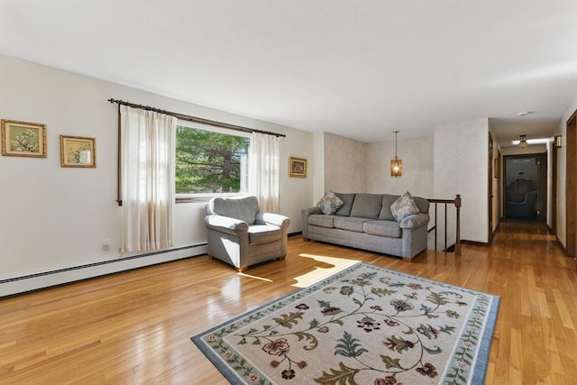 living room with baseboard heating and wood finished floors