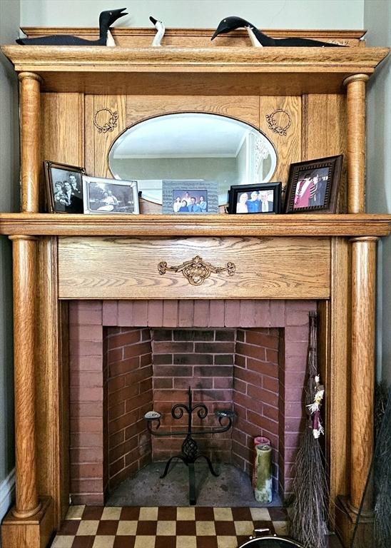 308 Hawthorn St, New Bedford, MA 02740 - detailed view of tile patterned floors, a fireplace, and ornamental molding