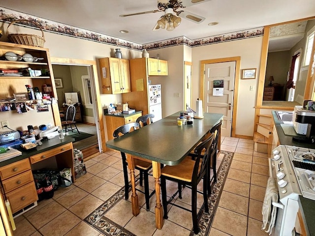 308 Hawthorn St, New Bedford, MA 02740 - kitchen with a ceiling fan, white gas range oven, light tile patterned floors, and dark countertops