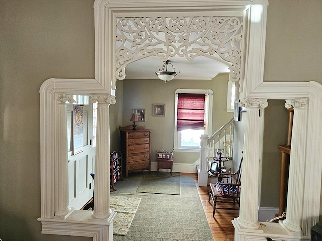 308 Hawthorn St, New Bedford, MA 02740 - entryway with ornate columns, arched walkways, wood finished floors, stairs, and baseboards