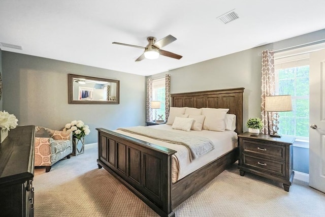 bedroom featuring light carpet, baseboards, and a ceiling fan