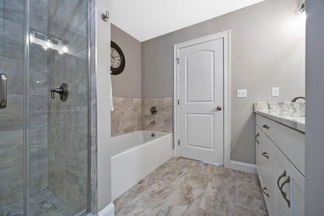 full bathroom with a stall shower, vanity, a garden tub, and baseboards
