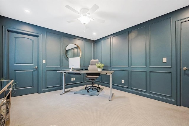 office area featuring a decorative wall, light colored carpet, a ceiling fan, and recessed lighting