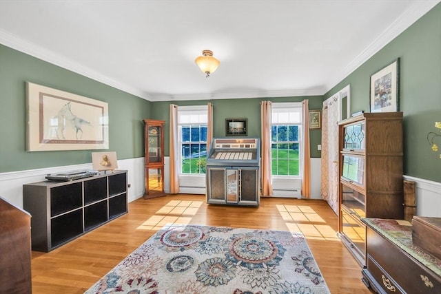 28 Sewall St, Shrewsbury, MA 01545 - sitting room featuring a baseboard heating unit, crown molding, wood finished floors, and wainscoting