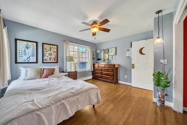 28 Sewall St, Shrewsbury, MA 01545 - bedroom featuring a baseboard heating unit, baseboards, wood finished floors, and ceiling fan