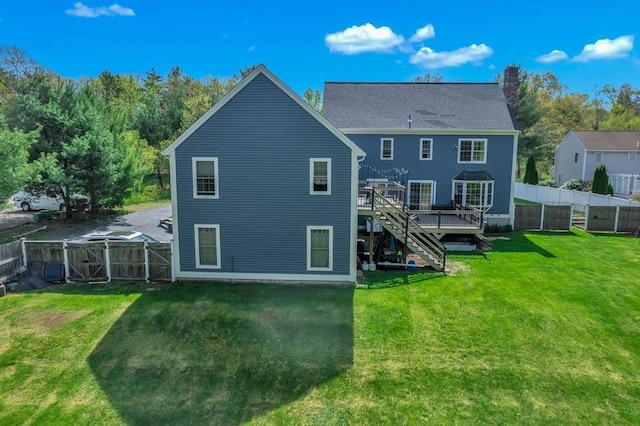 28 Sewall St, Shrewsbury, MA 01545 - rear view of house with stairway, a deck, a gate, and a chimney