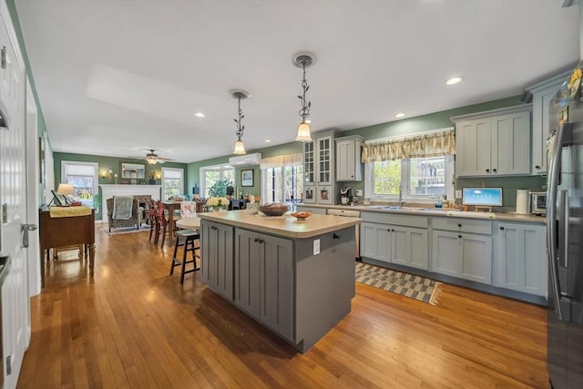 28 Sewall St, Shrewsbury, MA 01545 - kitchen featuring open floor plan, a center island, gray cabinetry, hardwood / wood-style flooring, and recessed lighting