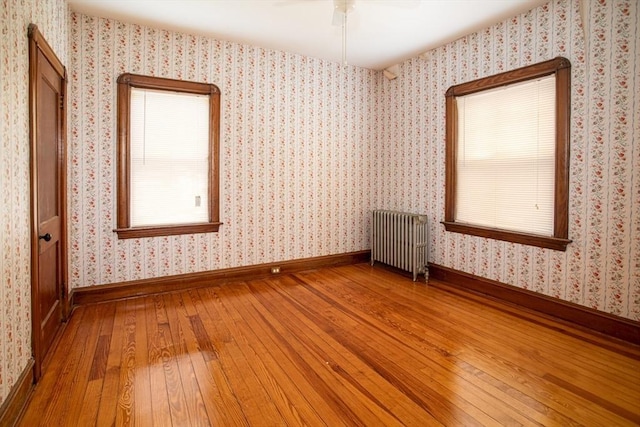 100 Weetamoe St, Fall River, MA 02720 - empty room with radiator heating unit, wood-type flooring, and a ceiling fan