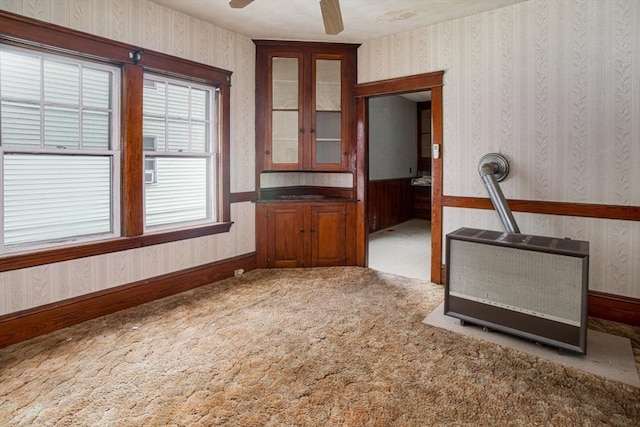 100 Weetamoe St, Fall River, MA 02720 - unfurnished living room with wallpapered walls, carpet, ceiling fan, and heating unit