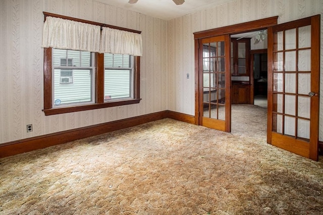 100 Weetamoe St, Fall River, MA 02720 - carpeted empty room featuring wallpapered walls, french doors, and a ceiling fan