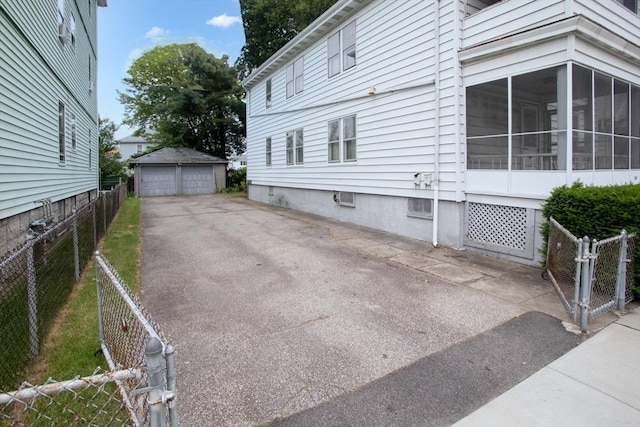 100 Weetamoe St, Fall River, MA 02720 - view of side of property featuring a garage and a sunroom