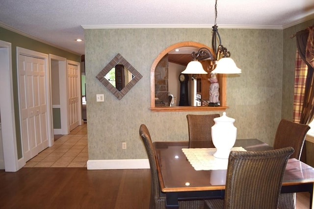 1820 Milk St, Dighton, MA 02715 - dining room with wood finished floors, crown molding, baseboards, and arched walkways