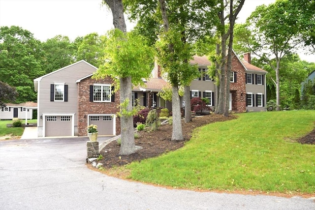 1820 Milk St, Dighton, MA 02715 - view of front of house with an attached garage, asphalt driveway, a front lawn, and a chimney